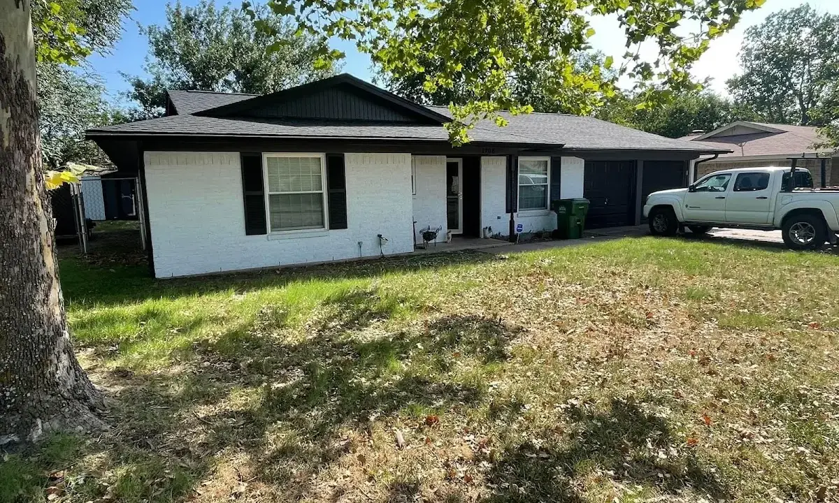 Professional roofing crew working on a residential roof in Pewaukee